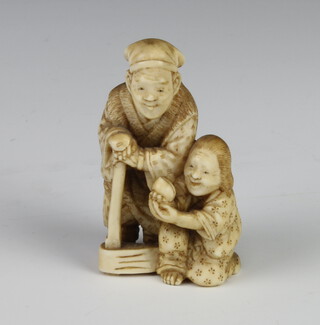 A Meiji Period Japanese ivory netsuke in the form of a standing gentleman and attendant, signed, 5cm 