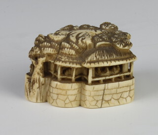 A Meiji Period Japanese ivory netsuke in the form of a pavillion on a rocky outcrop, signed, 4cm 