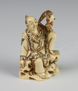 A Meiji Period Japanese ivory netsuke in the form of a man sitting on an outcrop with a bird on his left shoulder, signed, 5cm 