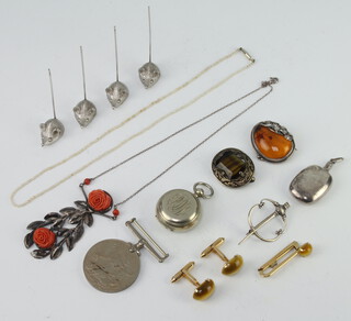 A silver mounted amberoid brooch, a coral pendant and minor costume jewellery