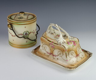 A Crown Devon biscuit barrel and cover decorated with floral swags and metal handle, a similar cheese dish and cover decorated with flowers 