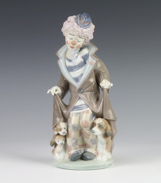 A Lladro figure of a clown with dogs at his feet 5901 24cm 