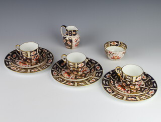 Three Royal Crown Derby Imari pattern trios together with a milk jug and sugar bowl 