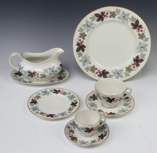 A Royal Doulton Camelot pattern part tea, coffee and dinner service comprising 12 coffee cups, 12 saucers, 10 tea cups, 10 saucers, 18 small plates, 14 dinner plates, 3 vegetable dishes and covers, 2 sauce boats and stands, 2 milk jugs, a cream jug, 2 sugar bowls, 10 soup bowls, 8 dessert bowls 