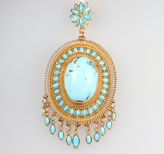 A yellow metal stamped 750, Egyptianesque pendant set with an oval cabochon turquoise and turquoise drops, 47.8 grams gross, 55mm x 45mm 