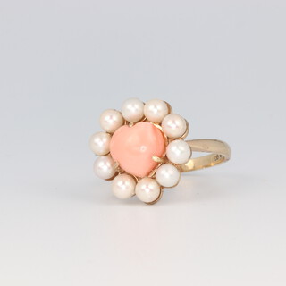 A 9ct yellow gold coral and seed pearl ring, the heart shaped coral 8mm x 9mm surrounded by 10 seed pearls each approx. 4mm, 4.6 grams 