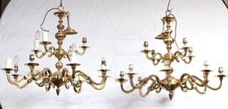 A pair of gilt metal twin drop 11 light electroliers 54cm h x 77cm 