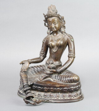 A bronze figure of a seated Goddess 31cm h x 23cm w x 17cm d 