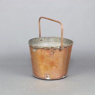 A circular copper pail with swing handle 35cm h x 47cm w (misshapen) 