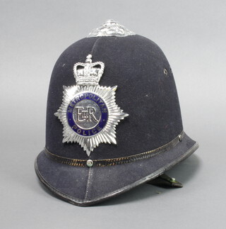 An Elizabeth II Metropolitan Police helmet complete with chin strap 