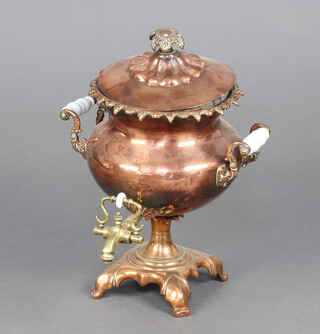 A Georgian copper twin handled tea urn complete with lead slug and glass isolating handles 33cm h x 32cm diam. 