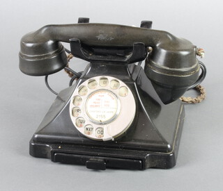A black Bakelite dial telephone, the base marked F/232F FWR 55/2 