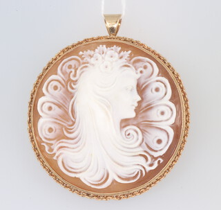 A good Victorian circular carved cameo brooch/pendant in the form of a young lady with flowers in her hair in a yellow metal mount 50mm 