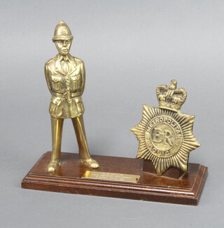 A Metropolitan Police brass presentation set comprising a facsimile helmet plate and standing police constable, the base marked To B Willis from Senior Officers Four Area 17/11/88 18cm h x 21cm x 9cm  