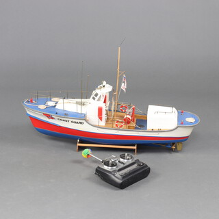 A radio controlled model of an American Coast Guard cutter 48cm x 71cm x 21cm complete with controls  