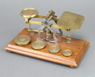 A set of brass letter scales complete with weights
 