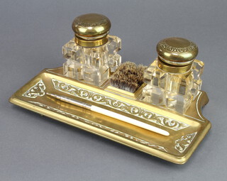 A Victorian brass and glass 2 bottle ink stand with 2 cut glass bottles, nib wipe and pen receptacle 9cm h x 24cm w x 14cm d (1 bottle has a large chip to the base) 