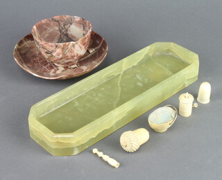 A 19th Century oval carved ivory pin cushion in the form of a basket 3cm, a ditto thimble case in the form of an acorn containing 2 steel thimbles 3cm, an ivory thimble 2cm  (split) a ditto tape measure 2cm x 1cm, ditto handle 3cm, a lozenge shaped green marble pen tray  3cm x 24cm x 7cm (chips to edge), turned marble tea bowl and saucer (both with chips) 5cm x 8cm 