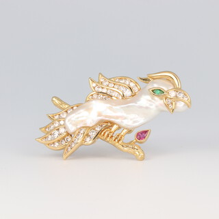 A 1970's 18ct yellow gold novelty brooch in the form of a parakeet, the body a long baroque pearl 37mm x 10mm at its widest, with an emerald eye, diamond feathers and ruby flower comprising 54 graduated brilliant cut diamonds 13.9 grams, 50mm h x 30mm w   