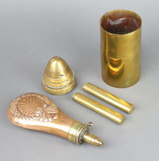 A 19th Century copper and brass embossed powder/shot flask 20cm x 8cm, 2 oval brass 2 oz shot measures 10cm x 1cm x 1.5cm, a brass shell nose cone 7cm x 8cm, a trench art vase 12cm h 