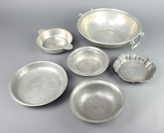 A circular Continental pewter twin handled bowl 10cm x 28cm, a circular pewter bowl the reverse marked YAR 1884 5cm x 6cm, 3 other pewter dishes, a Continental twin handled pewter quaich 4cm x 15cm 