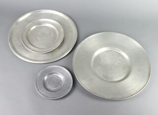 A circular pewter tray with Passavy Aylon touchmark 33cm (heavily marked and pitted), a Continental pewter charger with touchmark 33cm (some scratch marks), a pewter plate 20cm and a Continental ditto 15cm 