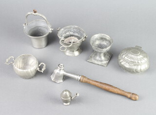 A miniature pewter side handled salt in the form of an acorn 5cm x 2cm, a pewter and turned oak candle snuffer, 2 pewter pails with swing handles 6cm x 8cm, pewter jar and cover 5cm, and 2 other pewter items