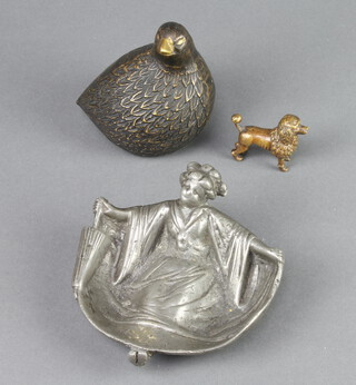 A bronze figure of a standing poodle 4cm x 4cm x 1cm, a bronze figure of a seated grouse 10cm x 8cm x 4cm and a metal ashtray 12cm 