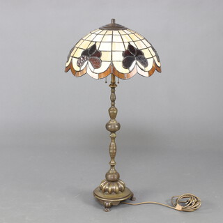 A Liberty style Art Nouveau gilt metal table lamp with lead glazed style shade, raised on hoof supports 35cm h x 41cm diam. 