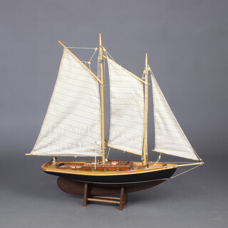A wooden pond yacht and stand 74cm h x 75cm w x 17cm d 