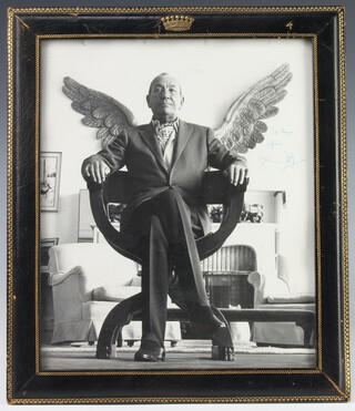 A signed black and white photograph of Noel Coward, inscribed "To Reggie from Noel" 28.5cm x 24cm, contained in an Asprey's black leather easel photograph frame with a coronet
 