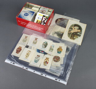 An Oxo tin containing various Players cigarette cards and a collection of silk cigarette cards 