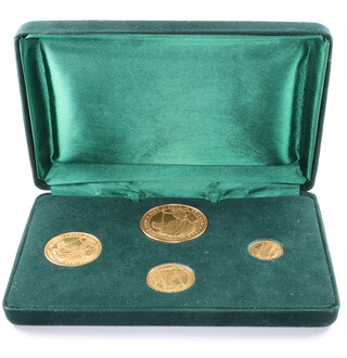A Britannia gold coin set comprising 100 pounds (1989), 50 pounds (1989), 25 pounds (1987) and 10 pounds (1987), 63 grams 
