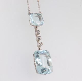 An Edwardian style topaz and diamond drop pendant, the cushion cut topaz 10mm x 10mm, the emerald cut topaz 17mm x 12mm, the 3 brilliant cut diamonds 0.15ct, the pendant 45mm long, on a 9ct chain 6.4 grams 