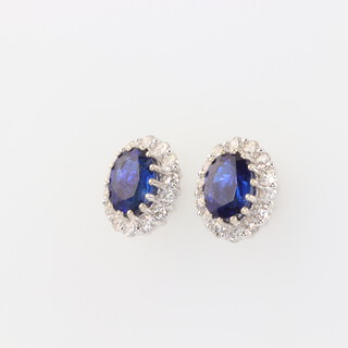 A pair of 18ct white gold oval kyanite and diamond ear studs, the centre oval cut stones 3.53ct, the 28 brilliant cut diamonds 1.04ct, 12mm x 10mm, 4.6 grams, with WGI certificate 