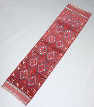 A red and blue ground Meshwani runner with 17 diamonds to the centre 250cm x 64cm  