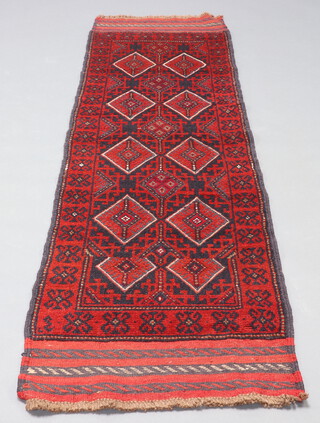 A blue and red ground Meshwani runner with 9 diamonds to the centre 238cm x 63cm 