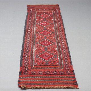 A red and blue ground Meshwani runner with 5 diamonds to the centre within a multi row border 260cm x 60cm 