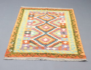 A green, brown and orange ground Chobi rug with 3 diamonds to the centre within a multi row border 153cm x 100cm 