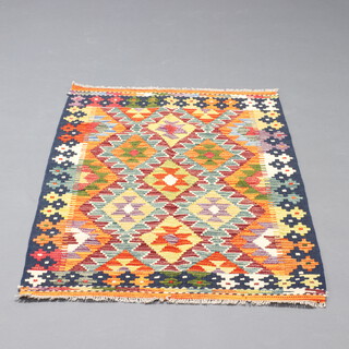 A turquoise, orange and green ground Chobi rug with all over geometric designs 126cm x 83cm 