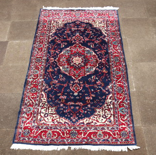 A North West Persian blue and red ground carpet with central medallion 252cm x 150cm 