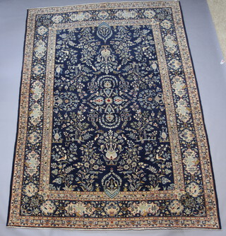 A blue and white ground North West Persian carpet decorated flowers, birds and deer 359cm x 261cm 