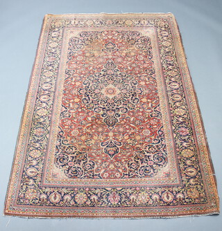 A North West Persian red and blue ground rug with central medallion within a multi row border 212cm x 138cm 