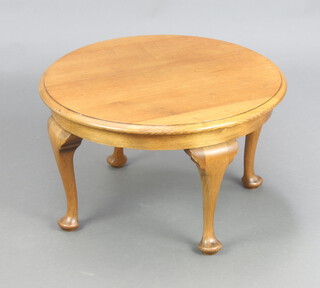 A circular light oak Queen Anne style coffee table, raised on cabriole supports 36cm h x 60cm diam.  