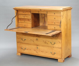 A Victorian pitch pine secretaire chest the fall front above 9 shallow drawers, the base fitted 3 drawers with brass swan neck drop handles 114cm h x 124cm w x 49cm d  