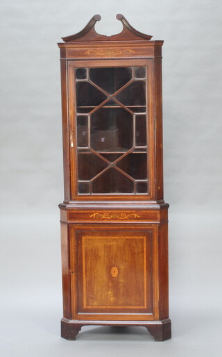An Edwardian inlaid mahogany double corner cabinet with shaped pediment, fitted shelves enclosed by astragal glazed doors, the base enclosed by a panelled door, raised on bracket feet 240cm h x 70cm w x 49cm w (in 2 sections) 