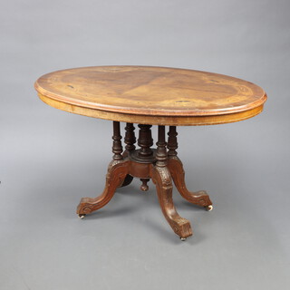 A Victorian inlaid quarter veneered snap top oval Loo table raised on 4 turned columns with splayed feet 74cm h x 116cm h x 79cm h  