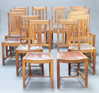 A set of 12 1920's oak stick and bar back chairs with drop in seats, raised on square tapered supports with H framed stretcher, the back of each chair is marked with the name of a scholar and a public school 96cm h x 45cm w x 40cm d (seats 30cm x 29cm) 