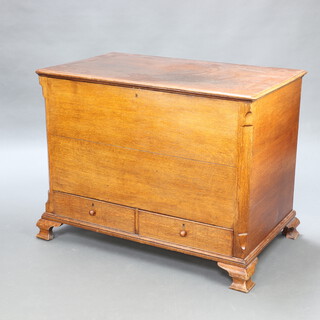 An 18th/19th Century light oak mule chest with hinged lid, the base fitted 2 drawers with tore handles, raised on bracket feet 85cm h x 110cm w x 66cm d 