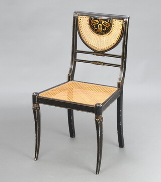 A Regency style black and gilt painted bedroom chair with woven cane seat and back, raised on sabre supports 80cm h x 45cm w x 40cm d (seat 28cm x 29cm) 